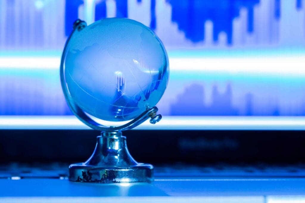 The business concept of the glass world on a laptop (s. climate, aid, science, news,globe)