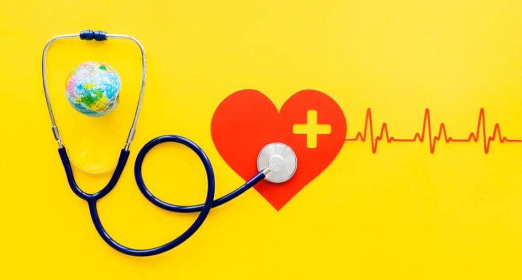 Image: Top view of paper heart with heartbeat and stethoscope