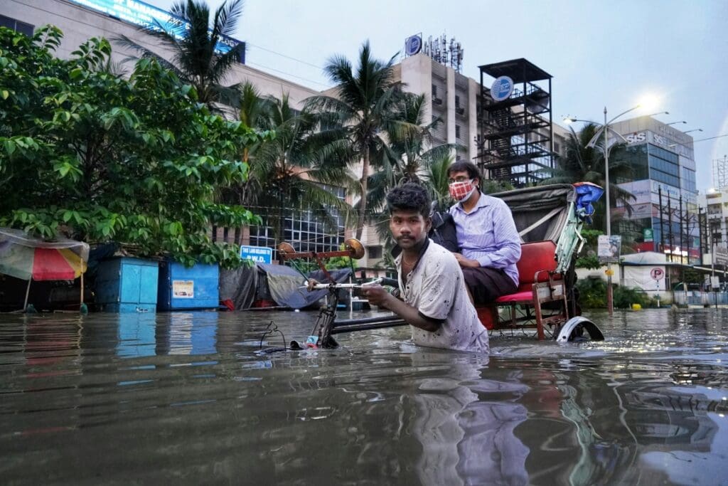 Image: a couple of men in a flooded street