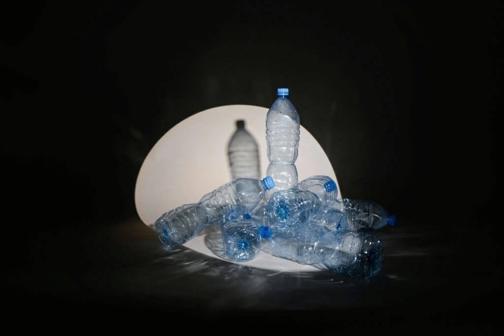 Image: A spotlight cast on plastic bottles on black background
