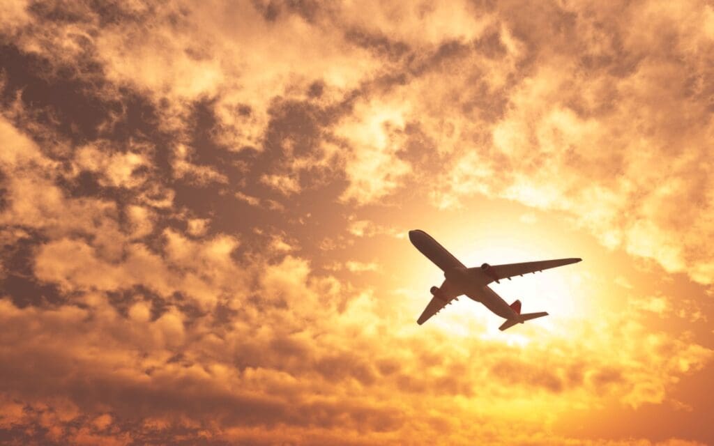 Image: Plane passing by the sun on a cloudy day