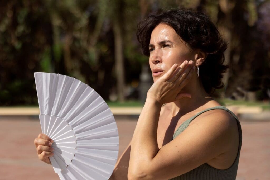 Image: Elder woman struggling with high temperature