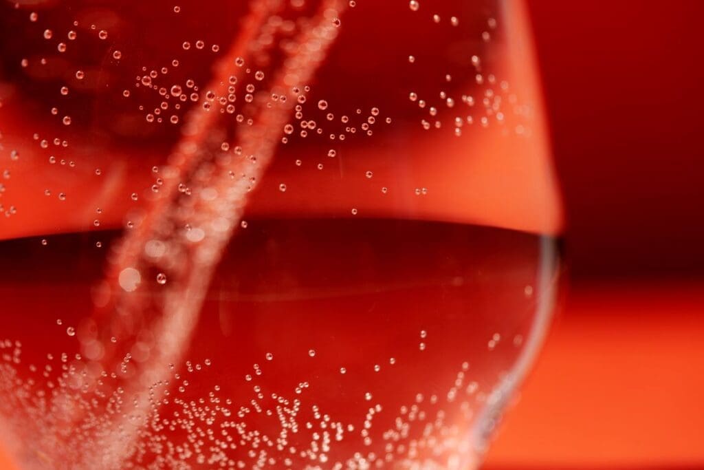 Image: Close- up of clear glass straw in liquid