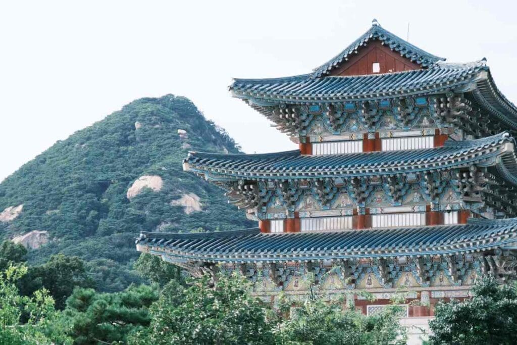 Image: brown and white temple near green trees during daytime