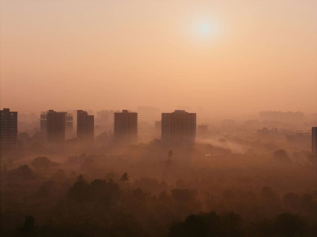 City buildings in the fog (s. air pollution, aerosols, dust, climate, science)