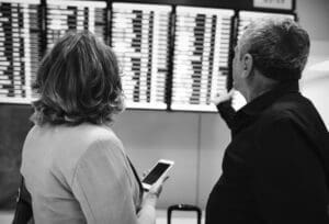Home Image: a couple checking flight time schedule (s. weather, winds)