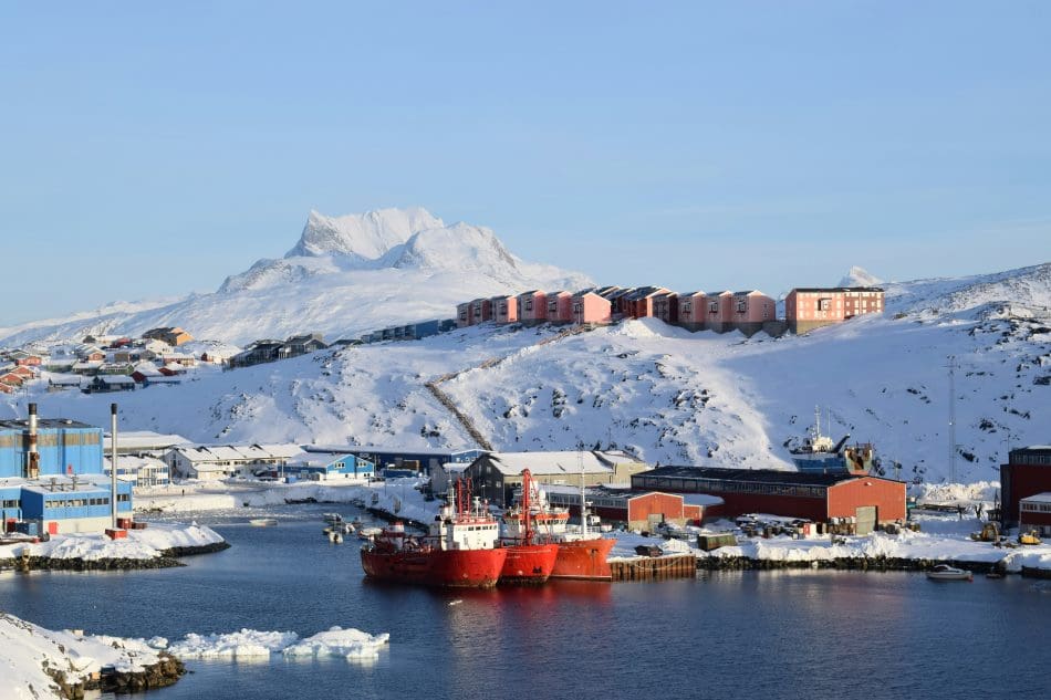 Image: red and white ship on sea near mountain (s. Nuuk, Greenland)