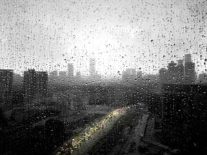 Home Image: a view of a city through a rain covered window