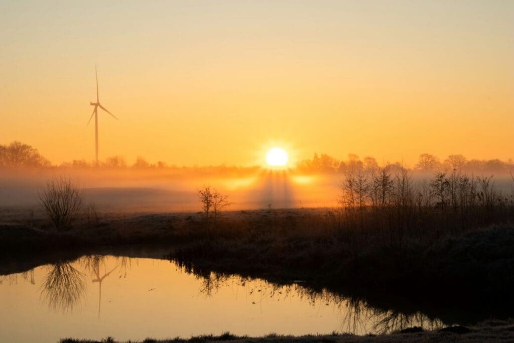 Home Image: solitary wind turbine stands tall on the horizon, symbolizing the blend of nature and sustainable energy