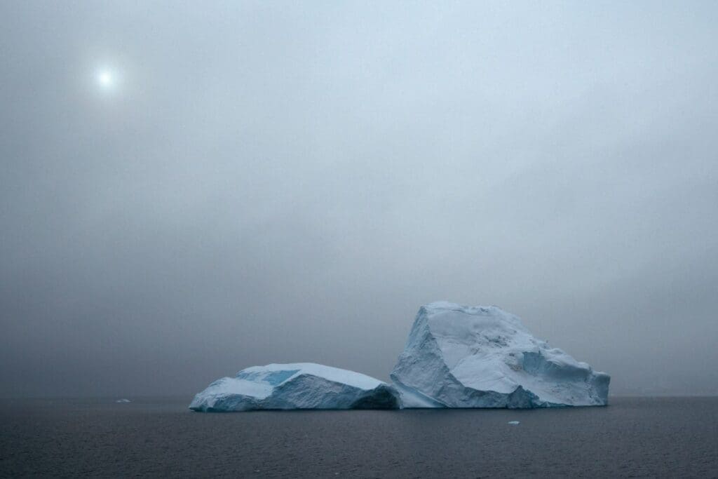 Home Image: icebergs float in a foggy ocean under sun (s. dimmed sunlight)