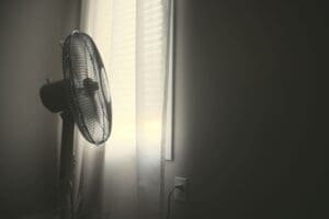 Home Image: white wall fan turned on near white window blinds