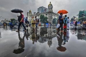 Home Image: a group of people walking down a street holding umbrellas