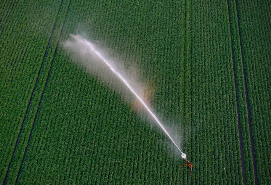 Home Image: Aerial photograph of an irrigation system watering a green field in Drenthe, Netherlands