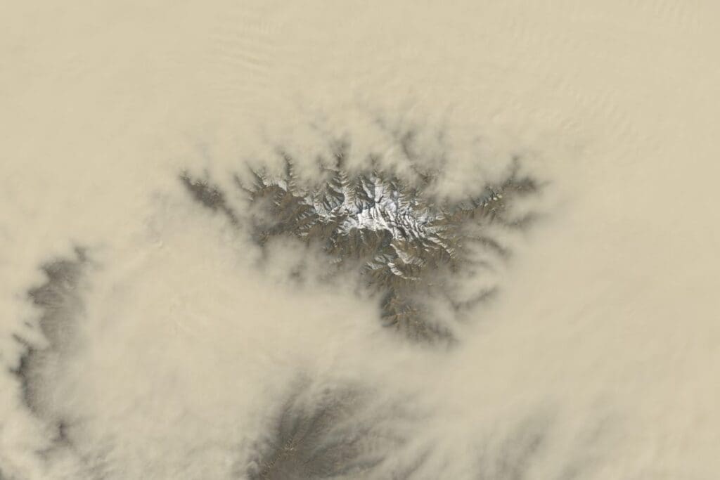 Satellite Image: On March 27, 2025, Landsat 8's Operational Land Imager (OLI) captured a break in the dust cloud over the southern Tarim Basin, briefly revealing the snow-covered peaks of the Tekilik Shan as a powerful spring dust storm swept across western China