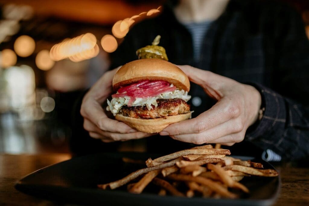 Home Image: a person holding a burger