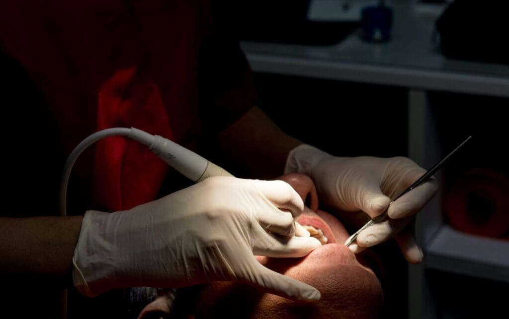 Home Image: Dentist cleaning patient's teeth with tools (s. Air pollution)