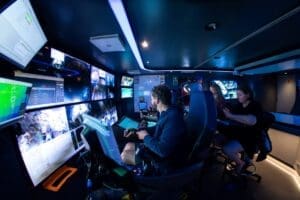 Home Image: Scientists monitor a deep-sea sampling dive from Mission Control aboard OceanXplorer