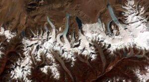 Home Satellite Image: Glacial lakes from retreating glaciers (termini of the glaciers in the Bhutan-Himalaya. Image provided by Jeffrey Kargel, USGS/NASA JPL/AGU)