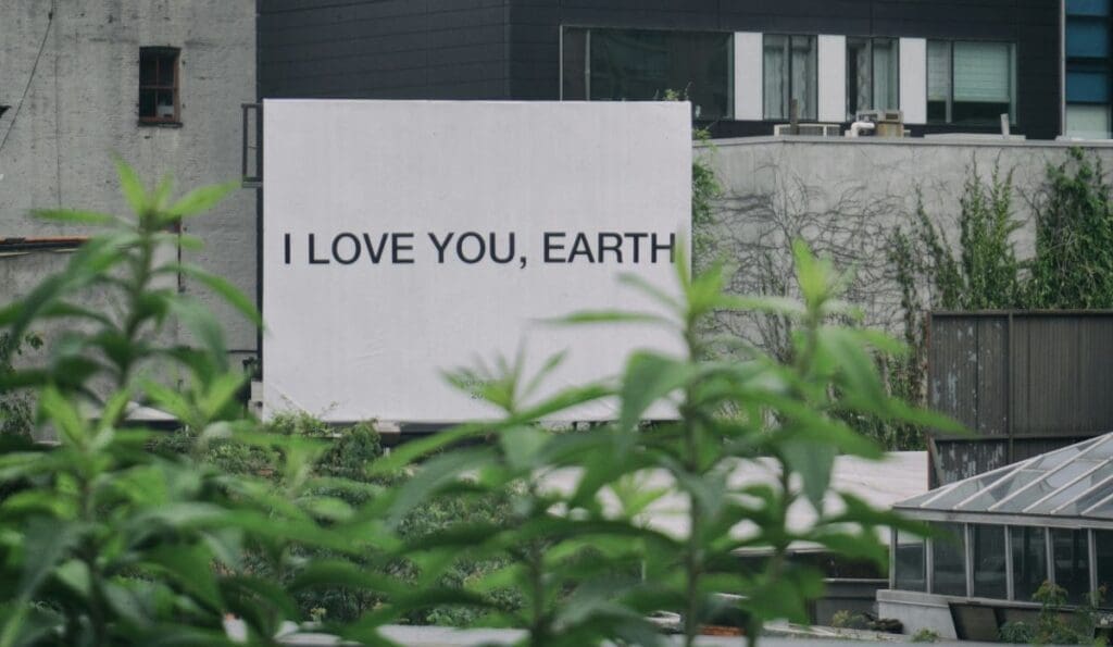 Home Image: a sign on a building with 'I love you, Earth' message, New York City