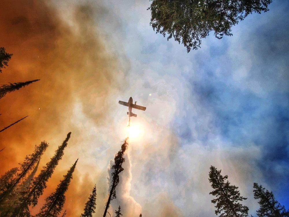 Home Image: A large airtanker makes a water drop on the Summit Trail Fire in Washington (s. air quality, wildfires)